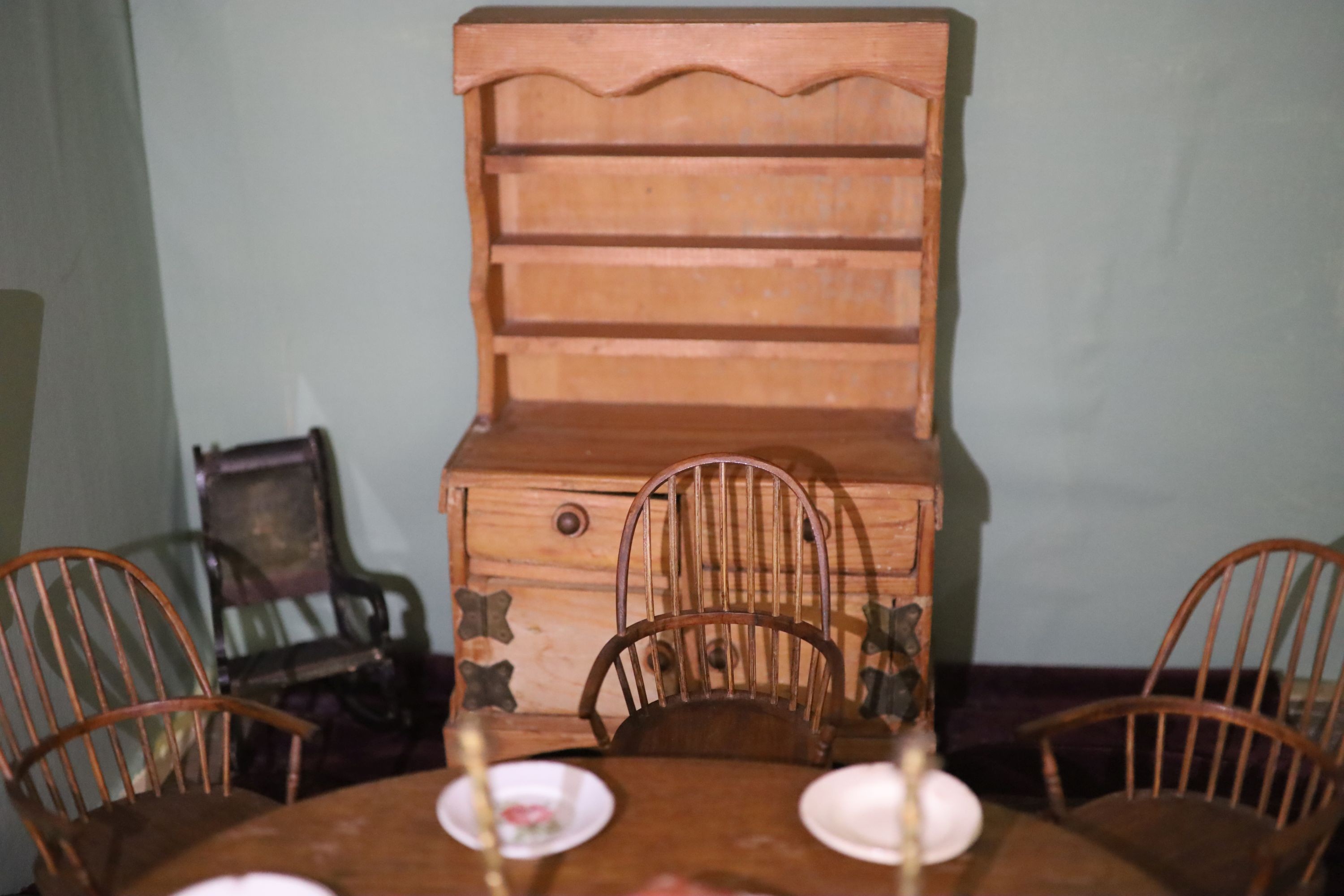 An unusually large painted pine doll's house, modelled upon a Victorian lodge house, Estate Carpenter made, Lake District width 198cm height 156cm